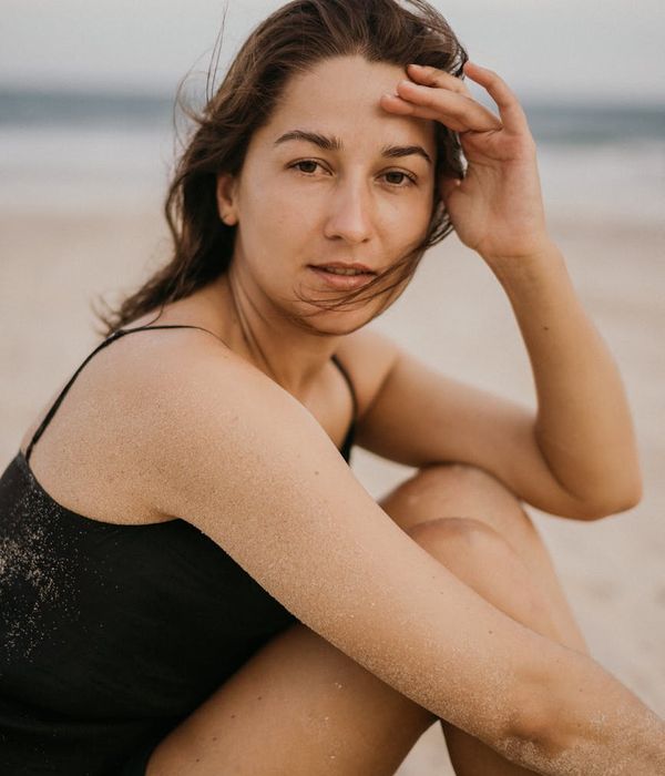 Woman in a peaceful meditation pose with warm and hazy background.